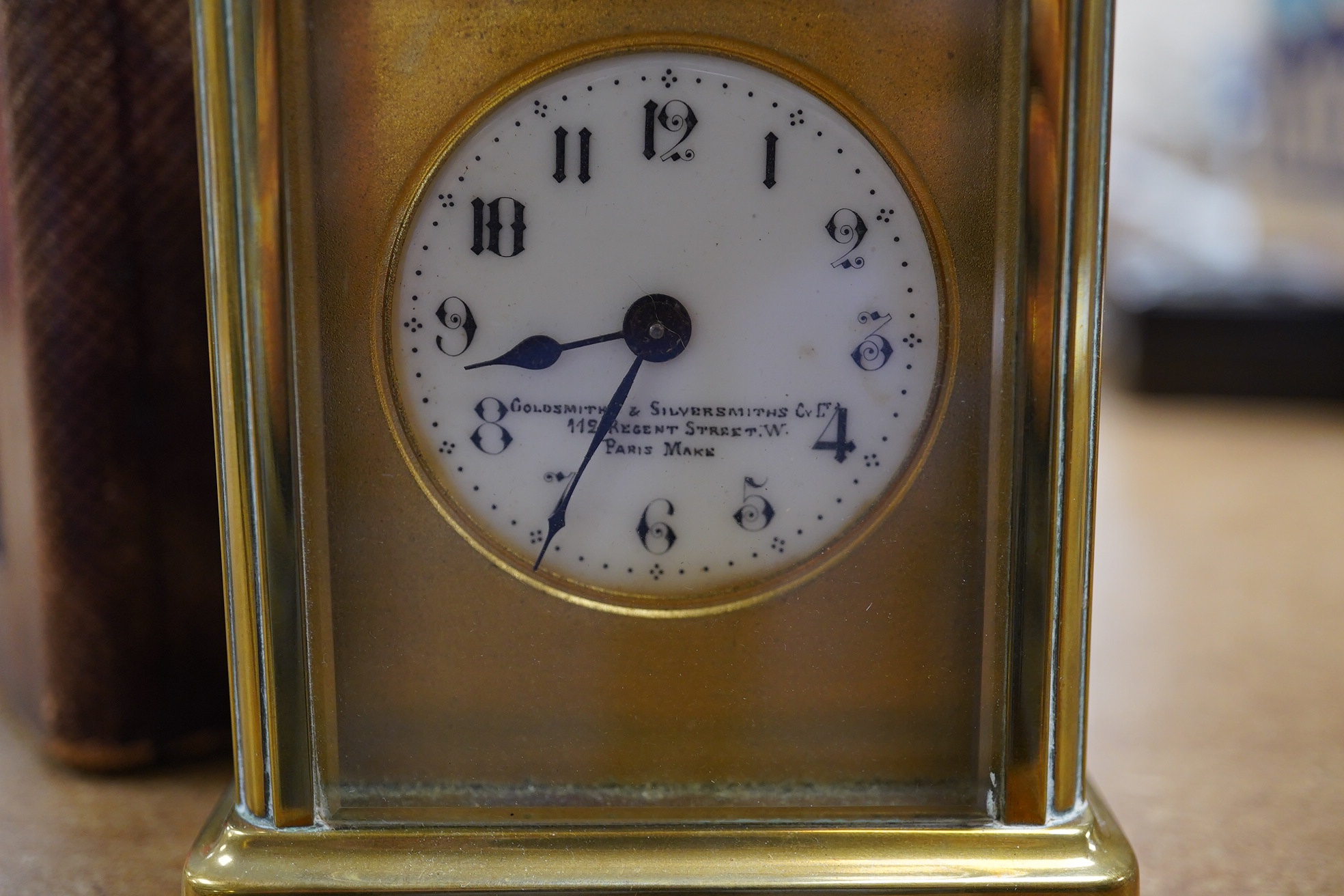 A brass cased carriage timepiece, the enamel dial inscribed ‘Gold & Silversmith’, with case, no key, 13cm high. Condition - good, untested